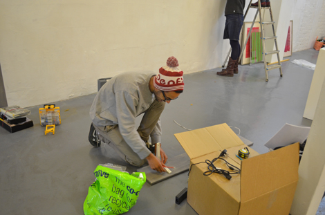 Samon Yechi fitting brackets on his shelf