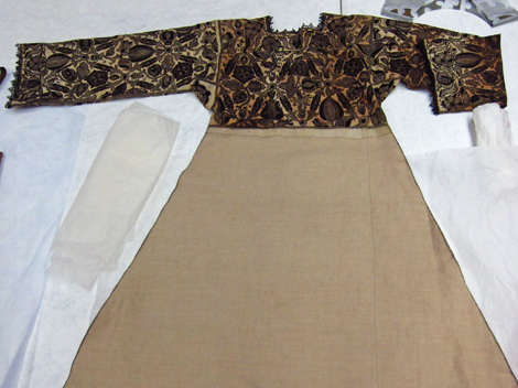A decorated linen smock, hand embroidered with silk in England, 1575 - 1585. The skirt and lace trim are modern.